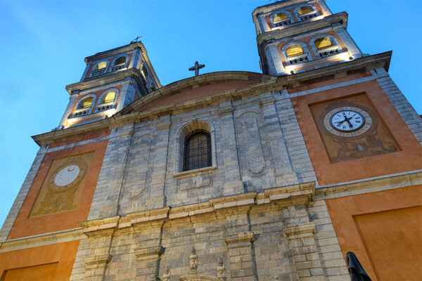 The facade of Eglise Notre Dame et St. Nicolas du Briancon at dusk
