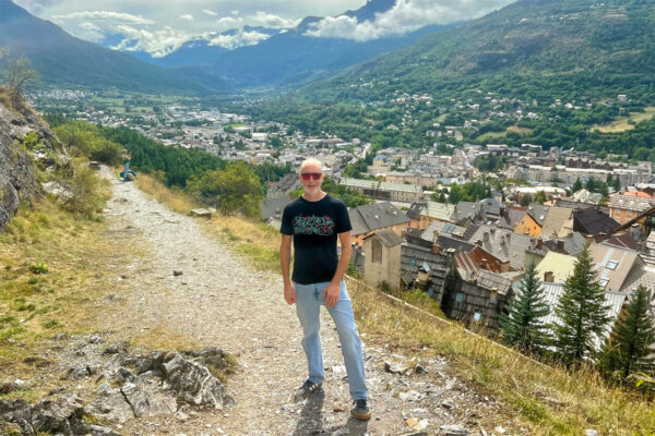 Matt on the Chemin du Ronde, Briancon with the town behind him