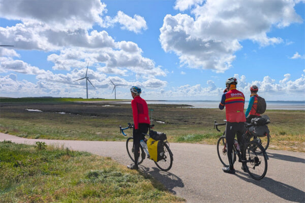 Three riders survey the cycle path round the bay near Ouwerkerk