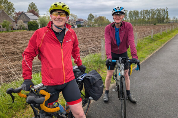 Two cyclists pose nect to some fields near Lembeke in Belgium