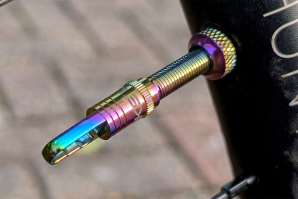 Uberbike tubeless tyre valve up close in oil slick finish